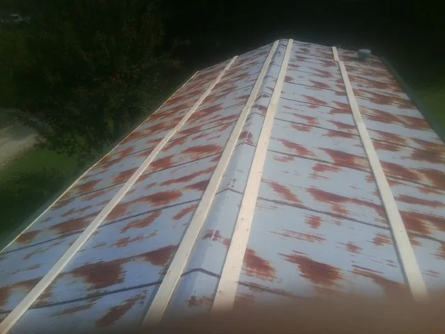 Rusted metal roof panels with new wood purlins before replacement — Storm Damage Roof Repair in Netcong by Roofing Brothers