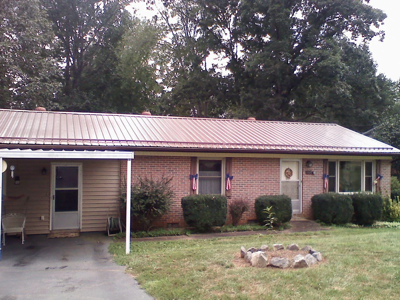 Bronze metal roof and carport on a brick ranch home — Roof Repair work by our crew in Netcong